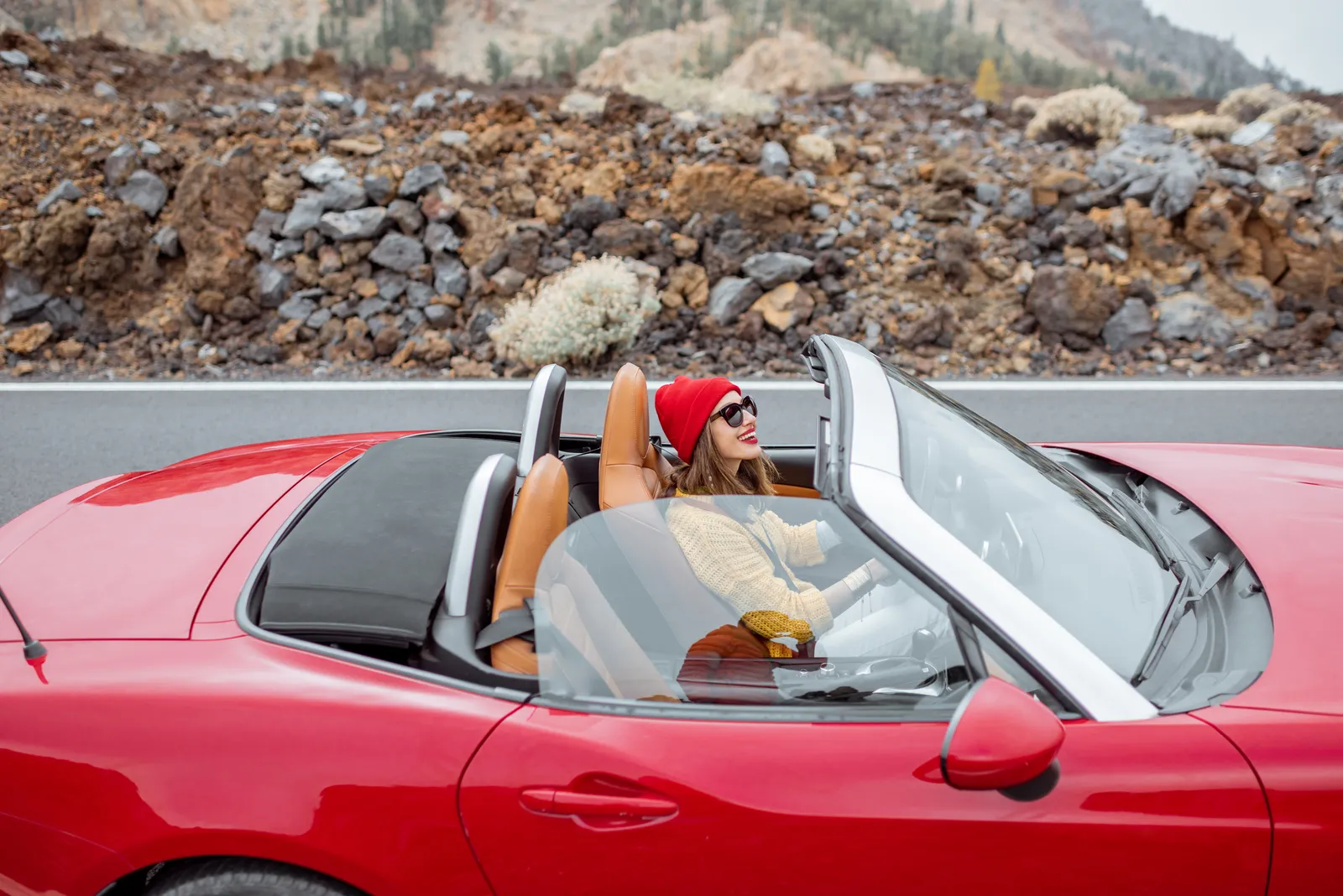 A driver relaxing in the red convertible she kept